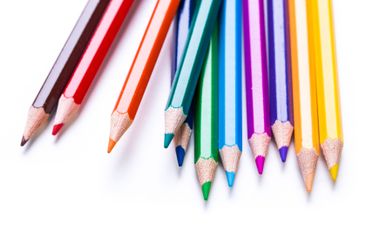 Colorful collection of sharpened pencils arranged in a...