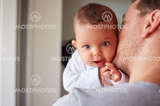 Portrait Of 3 Month Old Baby Daughter Being Held By...