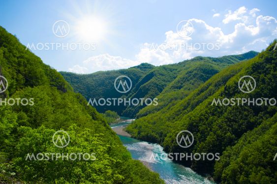 Summer landscape with river and cloudy sk