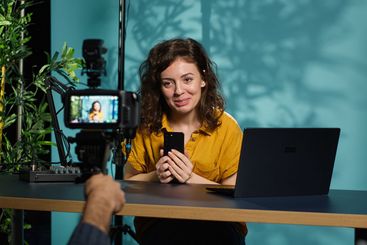 Woman filming video reacting to romantic text messages...