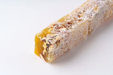 Traditional nougat with nuts and honey displayed on a...