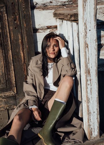 Beautiful fashionable brunette woman in gray coat on...