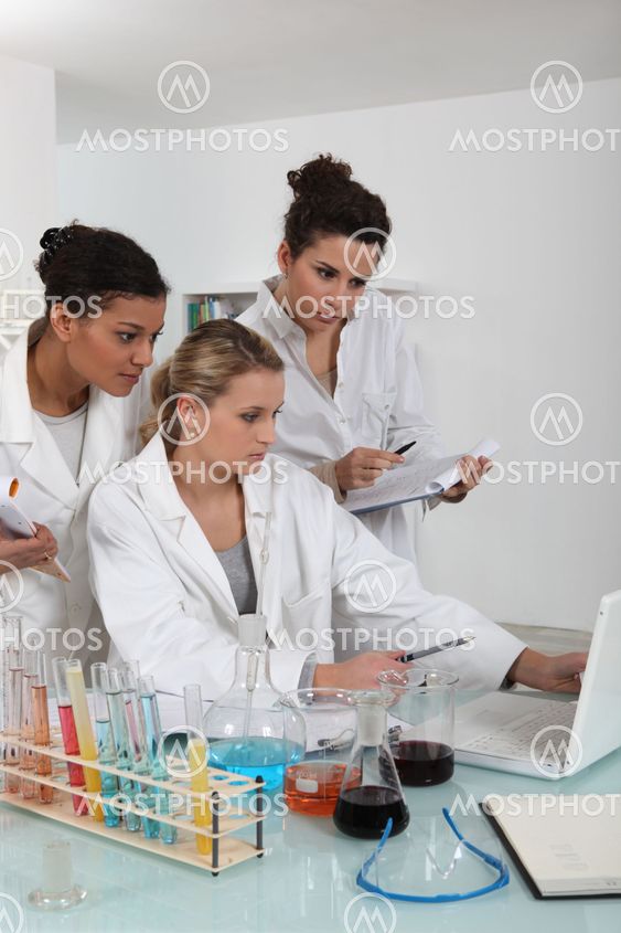 A team of female scientists examining the results of an experiment