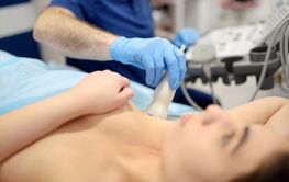 Mammologist doctor examines a woman breasts and lymph...