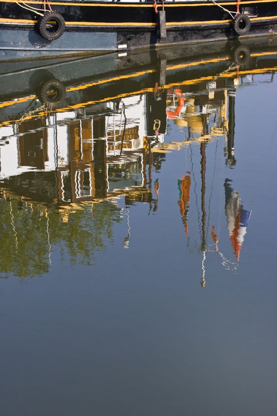 Reflection of part of ship with flags
