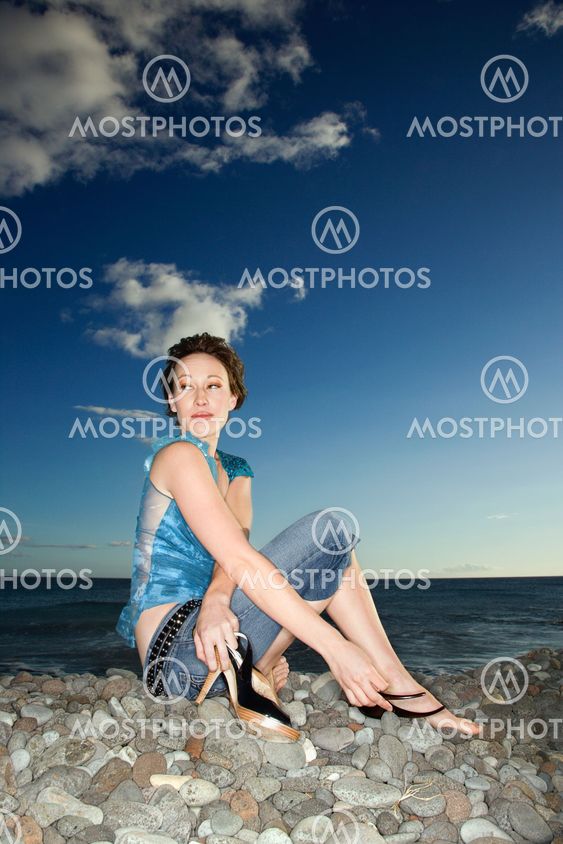 Woman sitting on beach.