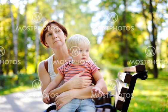 Woman and her toddler grandson enjoy sunny autumn day
