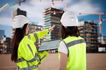 Female Construction Engineer Inspecting Site with Tablet...