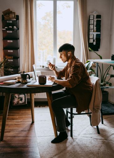 Male business professional talking through speaker phone...