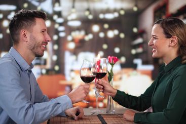 Portrait Of Romantic Couple Toasting Red Wine