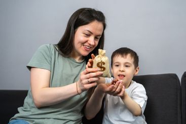 Mom gives her son a dollar money bag. Financial...