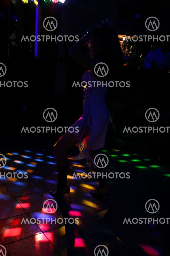 silhouette of a dancing girl in a white dress in the...