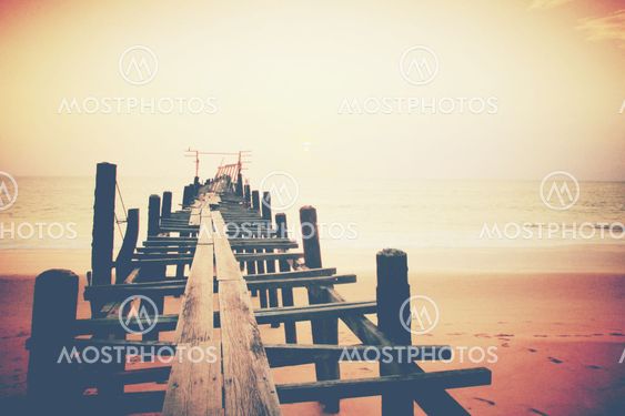 Old wood bridge to the sea