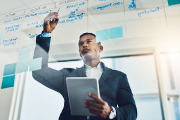 Business, man and writing on glass in office for...
