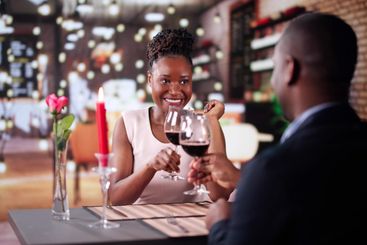 Portrait Of Romantic Couple Toasting Red Wine