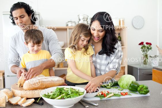 Positive family preparing lunch together