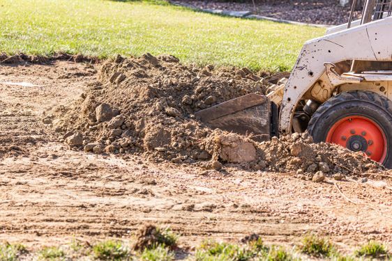 Small Bulldozer Digging In Yard For Pool Installation