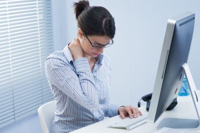 Tired businesswoman with neck pain