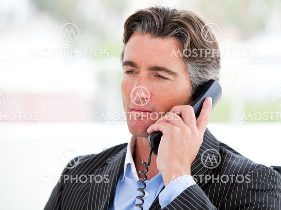Portrait of a self-assured businessman on phone