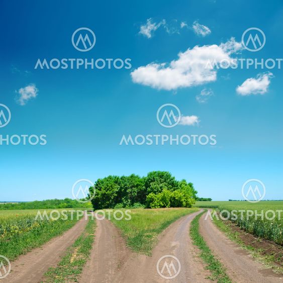 crossing of two rural road and deep blue sky