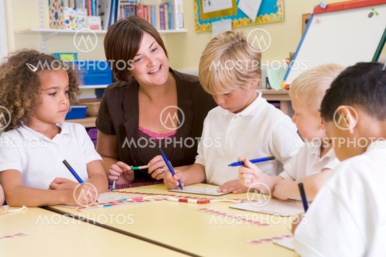 Schoolchildren and their teacher in a primary class