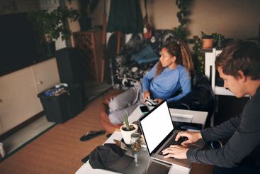 Couple, man and laptop for remote work in lounge,...
