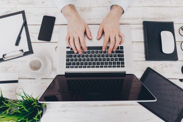 Businessman at work. Close-up top view of man working on...