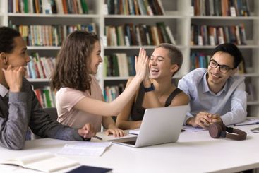 Laughing teen female give high five to happy hipster girl