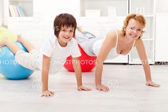 Happy woman exercising with her son