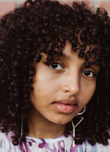 Portrait of African teenage against wall