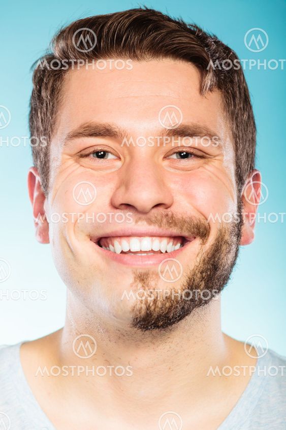 Happy man with half shaved face beard hair.