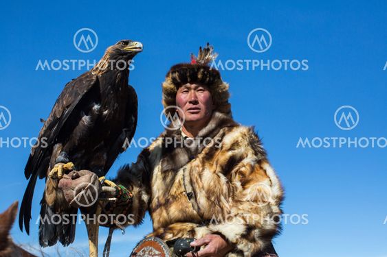 Kazakh Golden Eagle Hunter at traditional clothing, with...