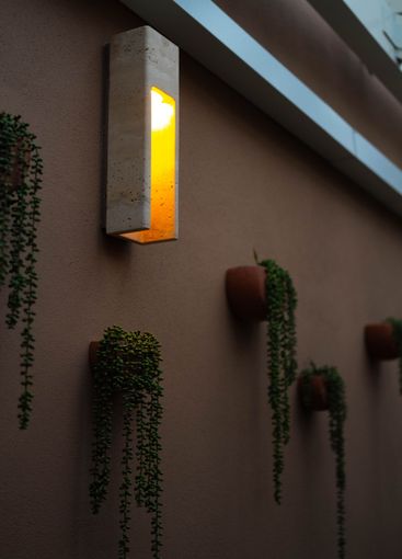 beautiful outdoor patio with moody lighting and hanging...
