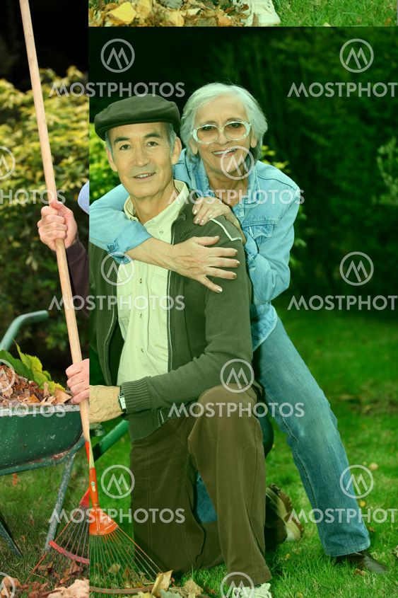 Old couple gathering leaves in garden