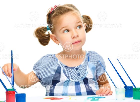 Little girl is painting with gouache
