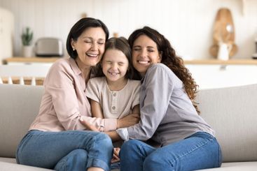 Older granny young mommy little daughter cuddling with...