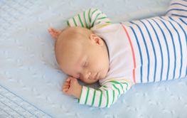 Little baby on white bed