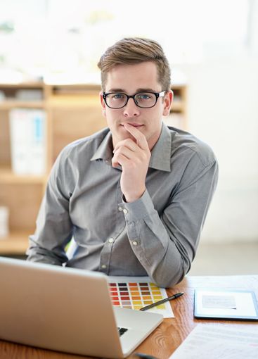 Man, laptop and color palette in office at startup,...