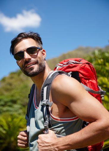 Hiking, journey and portrait with man in mountains for...