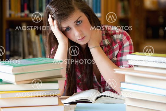 Depressed student surrounded by books