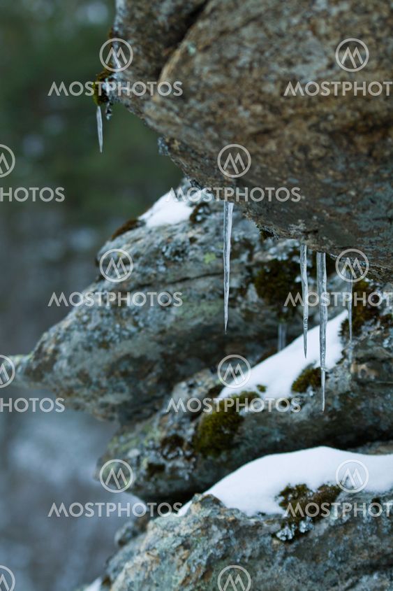 A close up of the icicles on rocks.