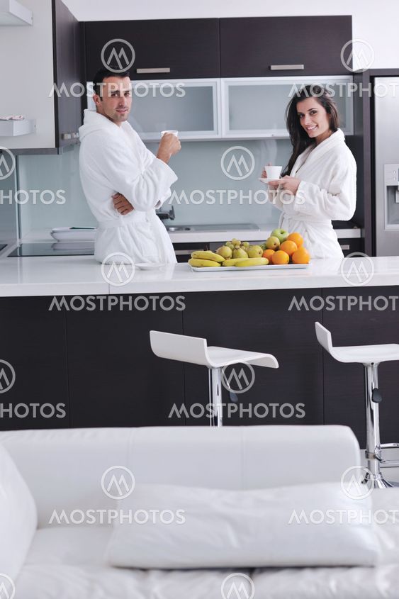 young couple have fun in modern kitchen