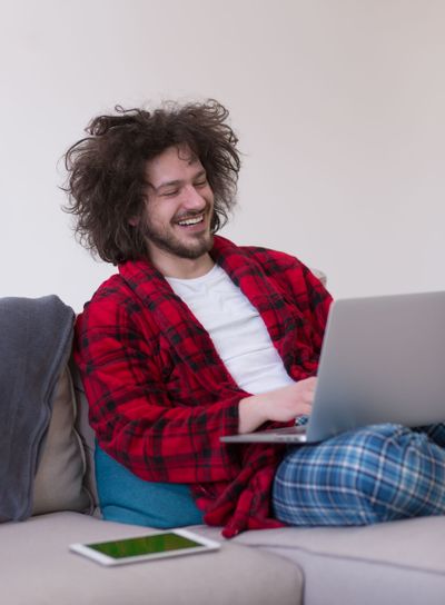 man freelancer in bathrobe working from home
