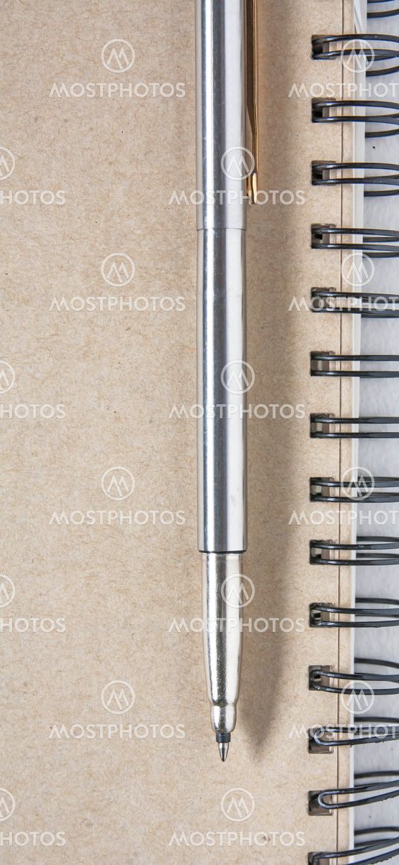A pen on a spiral notebook