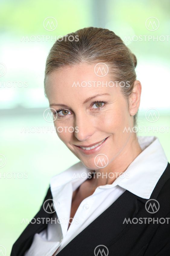 Head and shoulders of a smiling female executive