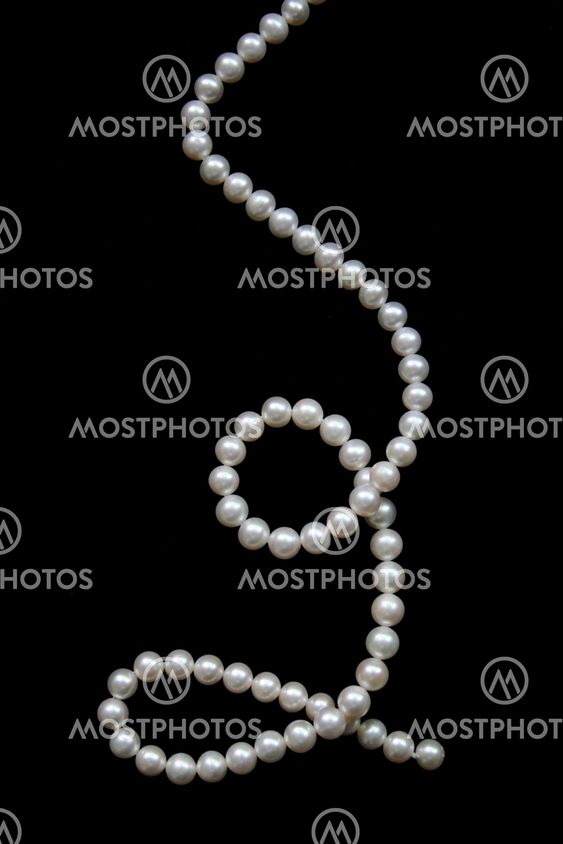 White pearls on the black velvet background