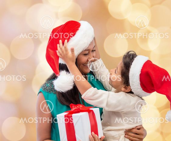 happy mother and child girl with gift box