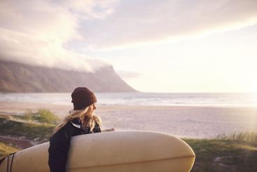 Woman, seaside and thinking with surfboard for practice,...