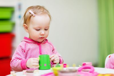Toddler girl playing with toys