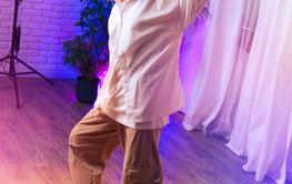 Confident dancer showcasing moves in a brightly lit...